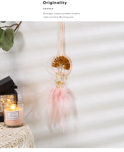 Detail of tree of life wall hanging with pink feathers and natural brown stones