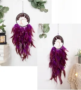 Detail of bohemian tree of life dream catcher with purple feathers and gemstone beads