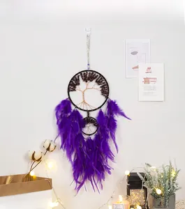 Detailed life tree dream catcher with purple feathers and stones in cozy home setting