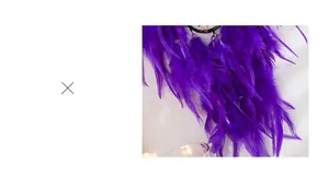Detailed close-up of vibrant purple feathers and translucent beads on a dreamcatcher
