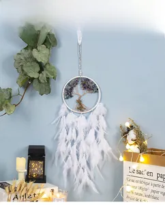 Detail of white dream catcher with tree of life wire art and soft feathers for home decor