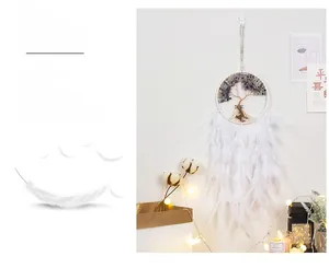 Detail of bohemian dream catcher with white feathers and tree of life deer silhouette