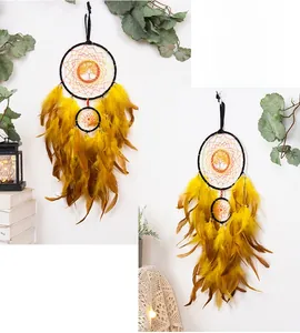 Detail of handmade Tree of Life dream catcher with warm yellow and brown feathers