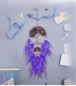 Detailed view of handmade purple Tree of Life dream catcher with stones and feathers