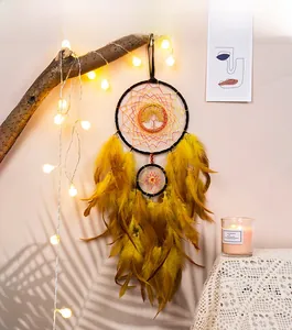 Detailed view of yellow dreamcatcher with Tree of Life wire weave and soft feathers