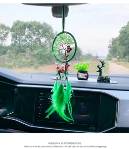 Green Tree of Life dream catcher car pendant with real feathers hanging on a rearview mirror