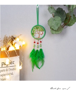 Detail of Tree of Life Christmas dreamcatcher with green feathers and Santa pendant