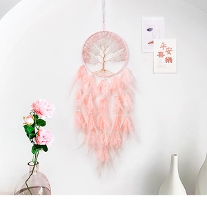 Detail of pink Tree of Life dreamcatcher with crystal stones and soft hanging feathers