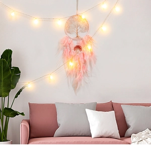 Pink feather dreamcatcher featuring a woven Tree of Life and white pearl bead accents