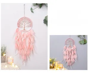 Detail of pink Tree of Life dream catcher with delicate feathers and beadwork for room decor