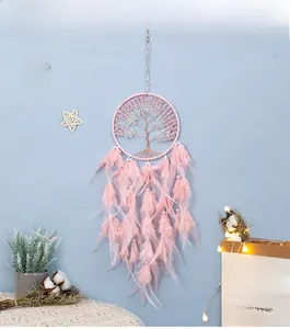Detail of life tree dream catcher with pink feathers and crystal stones for wall hanging