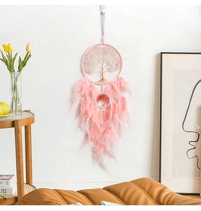 Detail of pink and white Tree of Life dreamcatcher wall decor in a modern home interior