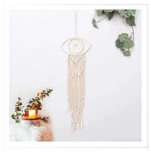 Close-up of Bohemian cotton rope evil eye wall hanging with long tassels and woven details