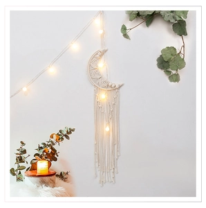Boho moon macrame wall hanging detail with warm LED lights and ivory cotton tassels