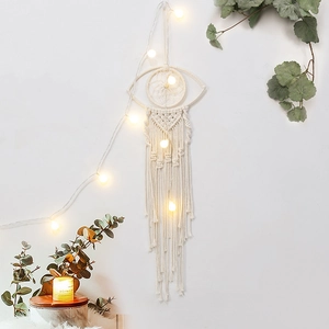 Bohemian woven macrame wall hanging in eye shape with fringe for home decor