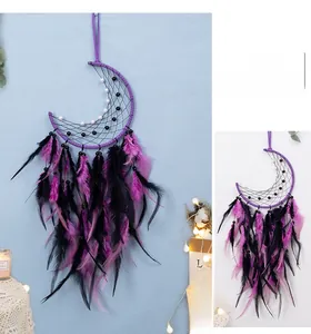 Close-up of handmade purple moon dream catcher with black feathers and woven beads