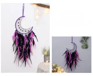 Detail of moon-shaped macrame dream catcher with purple and black feathers and beadwork