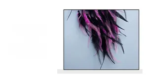 Detailed close-up of vibrant purple feathers and black beads on a woven dream catcher