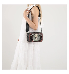 Detail view of Halloween crossbody camera bag with Keep Creepy skull print and wide strap