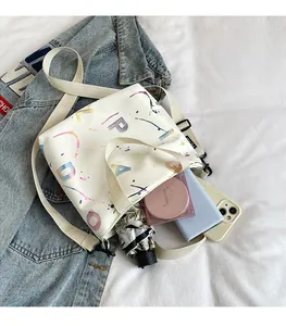Close-up of white crossbody bag with artistic colorful lettering and large capacity storage