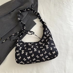 Minimalist black floral hobo bag with white bow pattern and ruched cloud strap detail