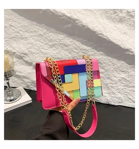 Detail of vibrant color-block square bag featuring metal chain and colorful PU leather texture