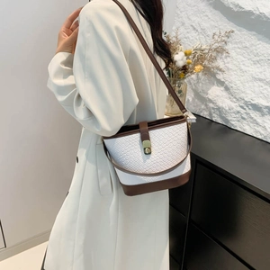 Chic two-tone bucket bag with white snake texture and dark brown leather details