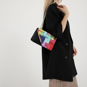 Colorful geometric block crossbody bag with gold chain strap shown from a side view