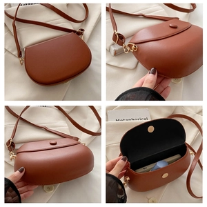 Detail view of vintage brown leather saddle bag interior showing space for essentials