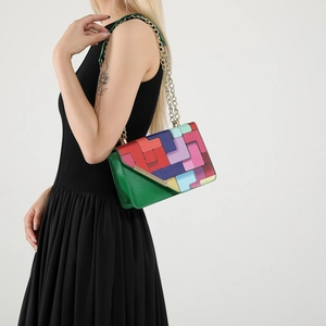 Colorful geometric block crossbody bag with gold chain strap shown on black dress