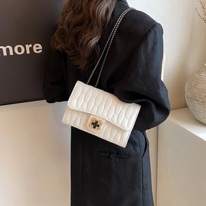 White croc-embossed crossbody bag with golden flower clasp and metal chain strap