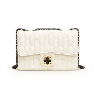 White quilted crossbody bag with wave texture and golden flower lock on chain strap