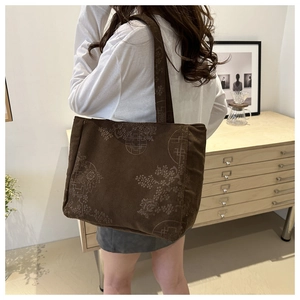 Detail of vintage brown corduroy tote bag featuring traditional Chinese floral patterns