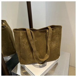 Detail of brown corduroy tote bag featuring vintage floral prints and thick texture