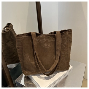 Detail of a brown corduroy tote bag with traditional Chinese floral patterns and twin straps