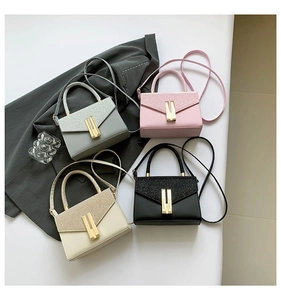 Top view of structured handbags in four colors featuring glitter flaps and gold buckles