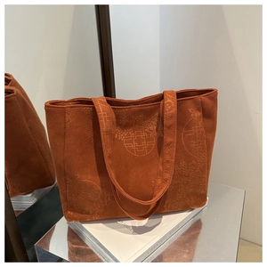 Detailed texture of burnt orange corduroy tote bag with traditional Chinese knot embroidery