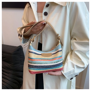 Detail of colorful hand-woven beach bag with vibrant stripes and leather strap close-up