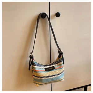 Close-up of colorful striped woven shoulder bag with FASHION BAGS label and leather strap