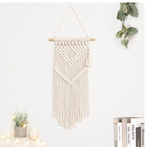 Detailed view of bohemian hand-woven cotton tapestry with elegant hanging tassels