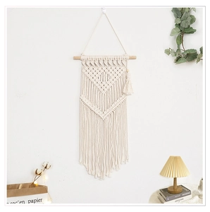 Detailed close-up of Bohemian cotton woven tapestry with tassel fringe and wooden beads