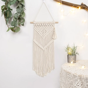 Bohemian hand-woven cotton macrame wall hanging with geometric patterns and fringe