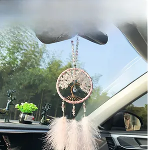 Macro shot of pink dreamcatcher car ornament with tree of life and delicate feathers