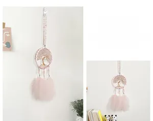 Detail of pink crystal life tree dream catcher with feathers and beaded decorations
