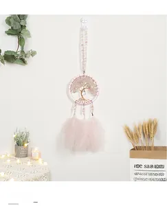 Detail of pink crystal tree of life dreamcatcher with soft feathers and beads
