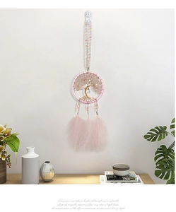 Detail of pink crystal Tree of Life dream catcher with feathers for car and home decor