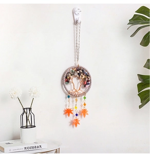 Detail of tree of life dreamcatcher with colorful stones and orange maple leaf pendants