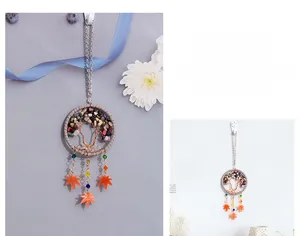 Detail of life tree dreamcatcher with colorful stones and orange maple leaves