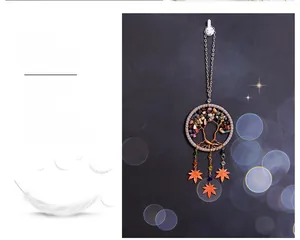 Detail of Tree of Life dream catcher car charm with colorful stones and orange leaf pendants