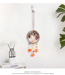 Detail of life tree dream catcher car pendant with colorful stones and maple leaf charms